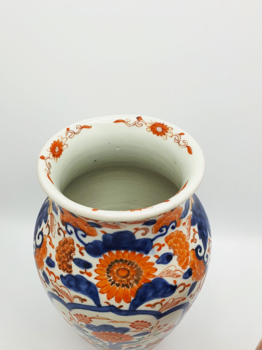 A pair of antique Japanese Imari porcelain vases decorated with cobalt blue and iron-red floral motifs within framed panels. View VI