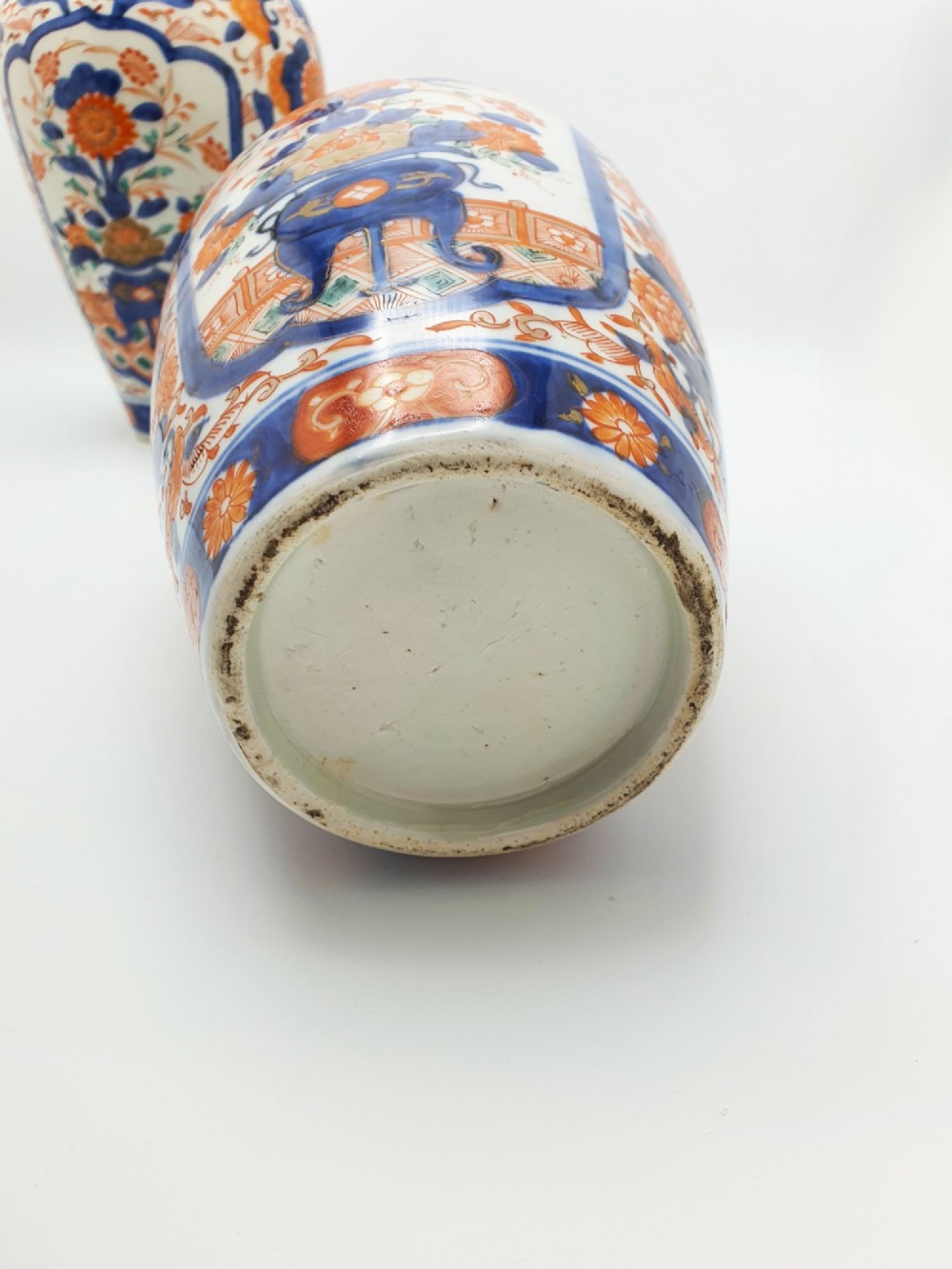 A pair of antique Japanese Imari porcelain vases decorated with cobalt blue and iron-red floral motifs within framed panels. View VIII