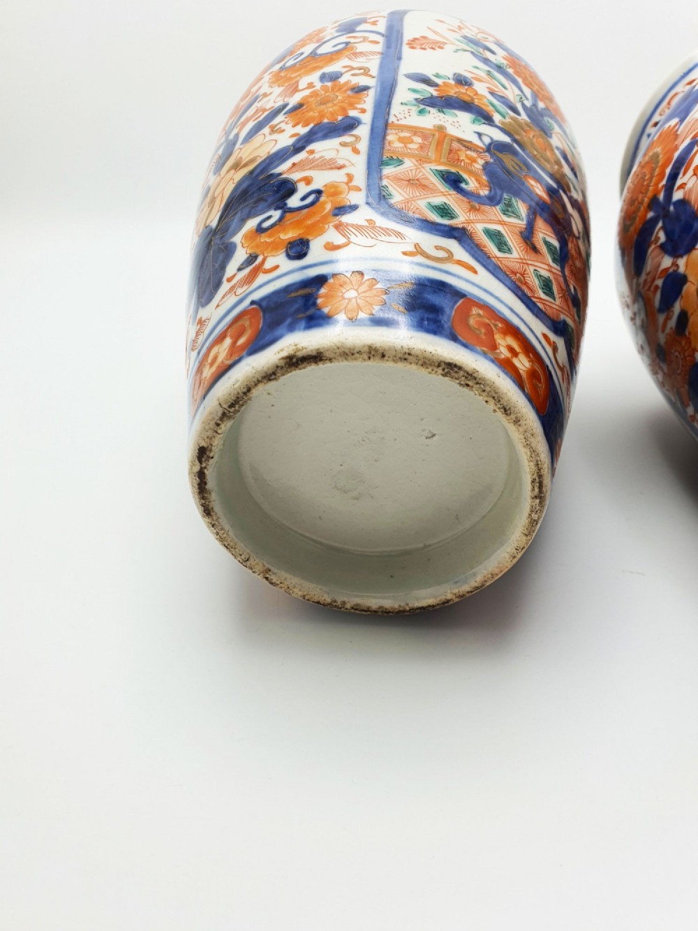 A pair of antique Japanese Imari porcelain vases decorated with cobalt blue and iron-red floral motifs within framed panels. View IX