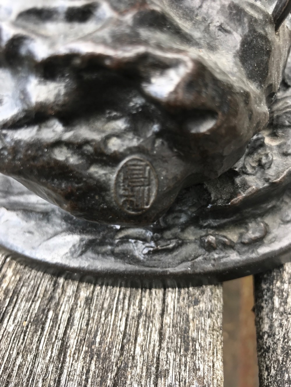 A dark patinated bronze okimono sculpture depicting a standing Japanese fisherman holding a tall rod with a basket slung over his shoulder. View V