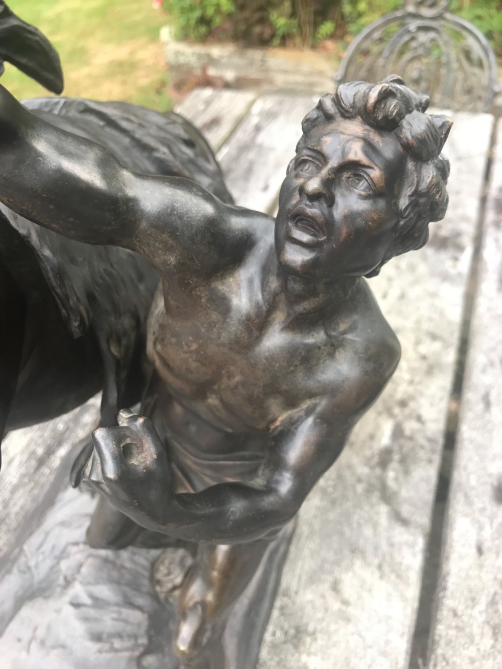 A dark patinated bronze sculpture depicting a muscular male groom attempting to restrain a rearing horse on a naturalistic base. View II