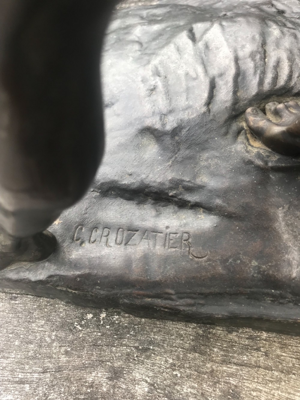 A dark patinated bronze sculpture depicting a muscular male groom attempting to restrain a rearing horse on a naturalistic base. View IV