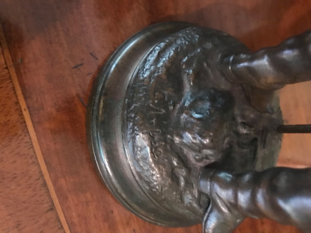 A patinated dark bronze sculpture of a 19th-century French military standard bearer holding a flag staff and cane. View III