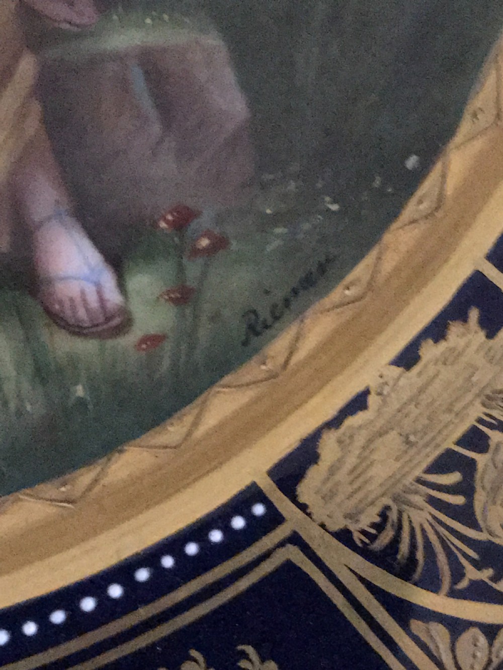 An octagonal antique porcelain cabinet plate with a cobalt blue and gold gilded border surrounding a central hand-painted scene of a classical woman and cherub. View IV