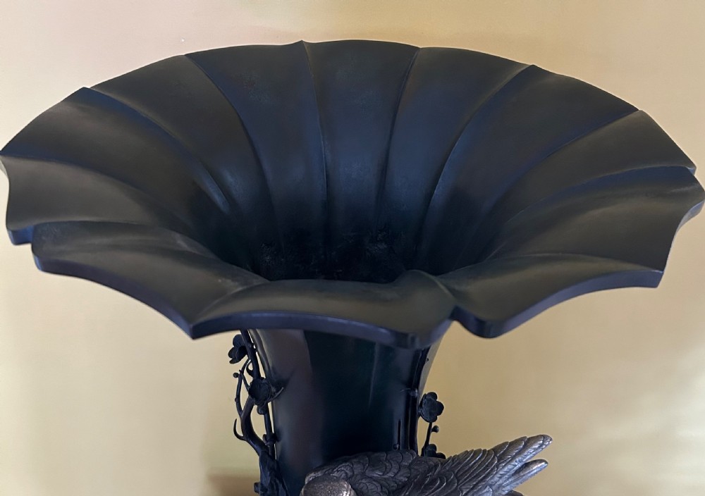 A dark patinated Japanese Meiji period bronze vase featuring a flared scalloped rim and a sculptural hawk perched on high-relief rockwork. View V