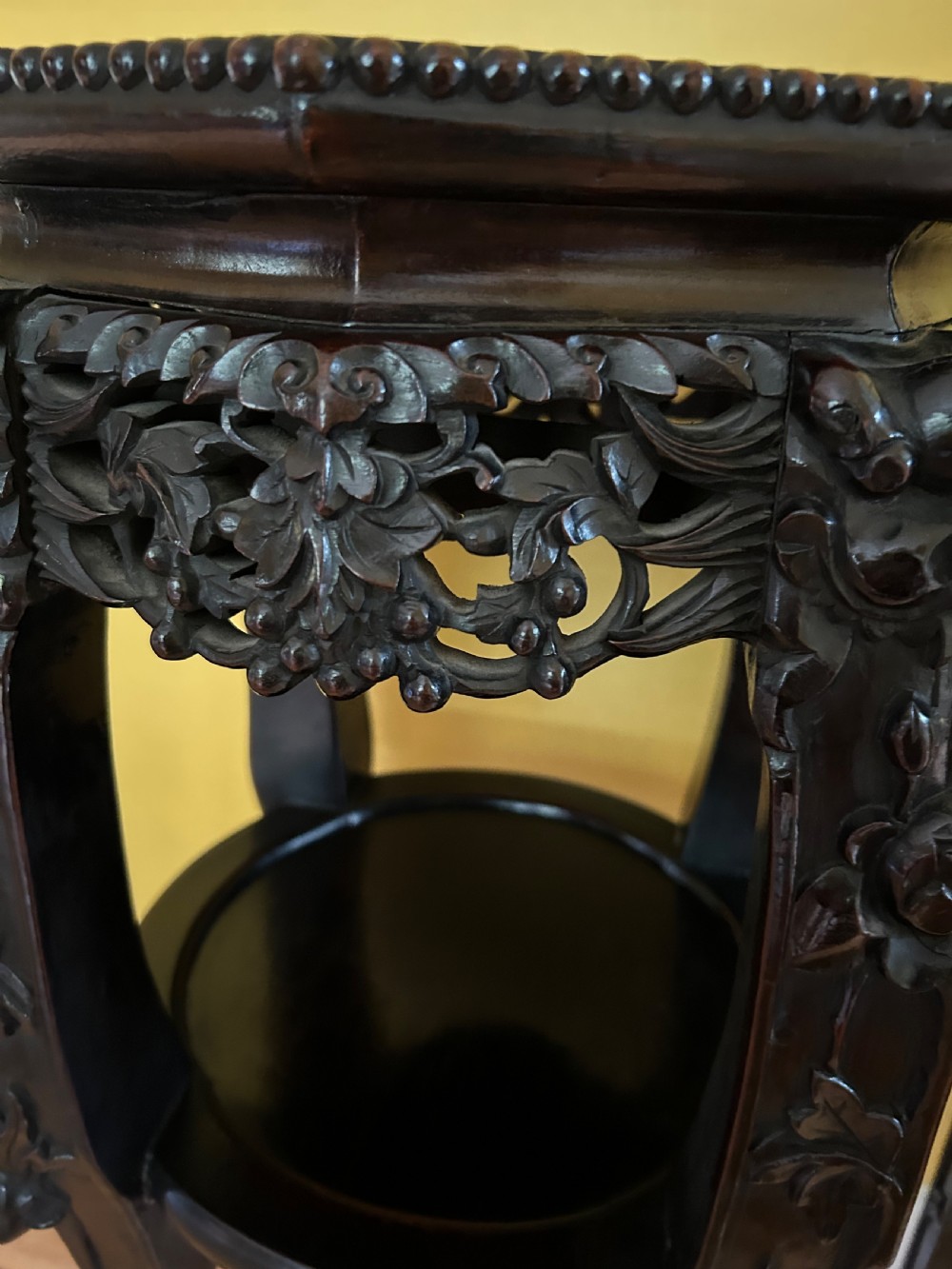 A pair of octagonal Chinese dark padouk wood plant stands with inset marble tops, pierced openwork aprons, lower shelves, and claw feet. View VIII