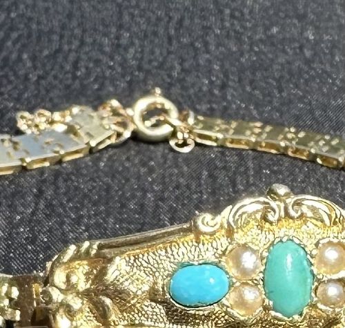 An antique 18ct gold bracelet featuring an ornate central panel set with three turquoise cabochons and seed pearls attached to a flexible gold link strap. View III