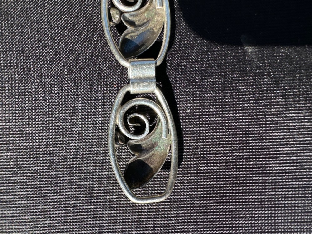 A Danish 830 silver link bracelet featuring oval openwork links with sculpted leaf forms, spiral scrolls, and bead accents. View V