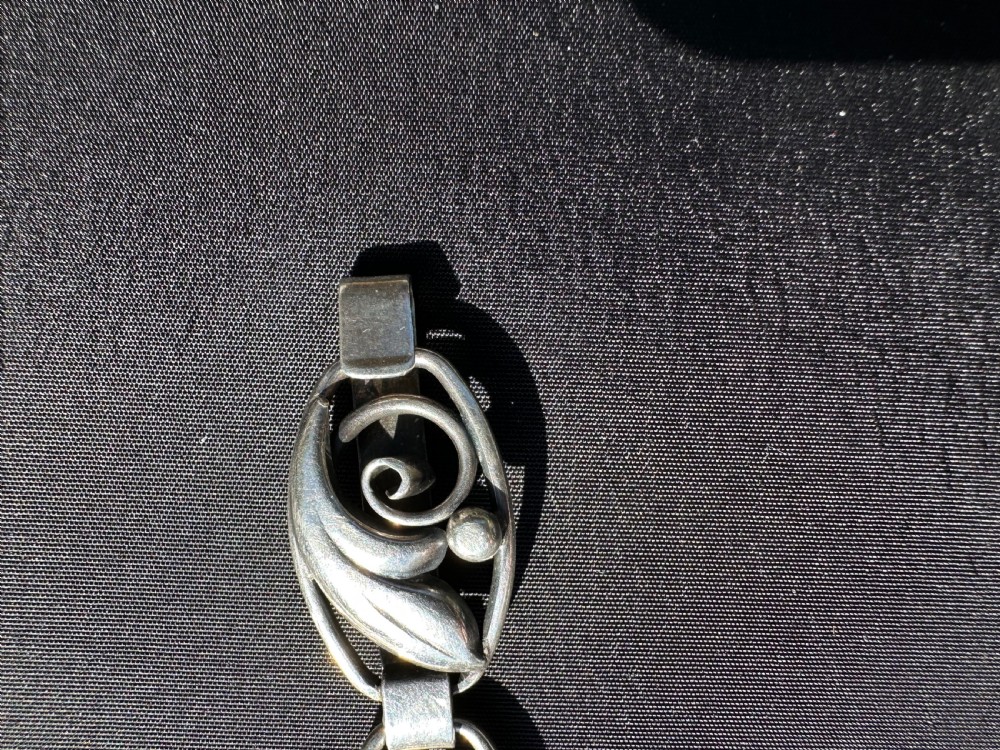A Danish 830 silver link bracelet featuring oval openwork links with sculpted leaf forms, spiral scrolls, and bead accents. View VI