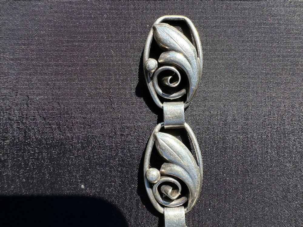 A Danish 830 silver link bracelet featuring oval openwork links with sculpted leaf forms, spiral scrolls, and bead accents. View VII
