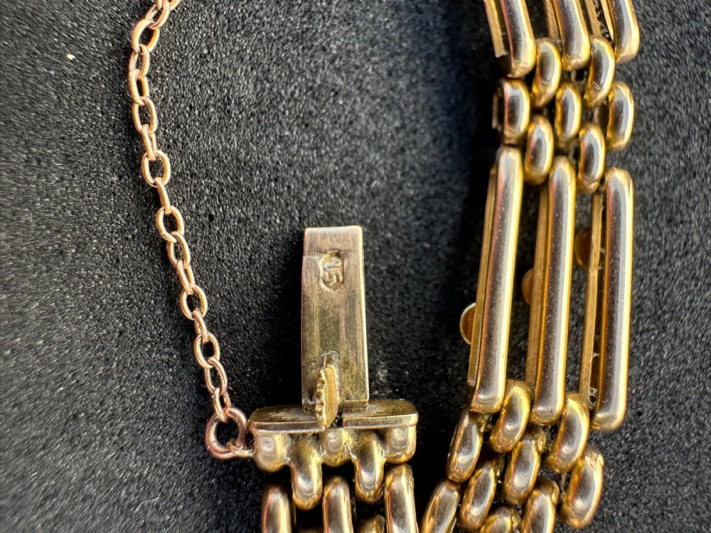 An antique 15ct yellow gold link bracelet featuring set turquoise cabochons and small seed pearls along structured openwork links. View V