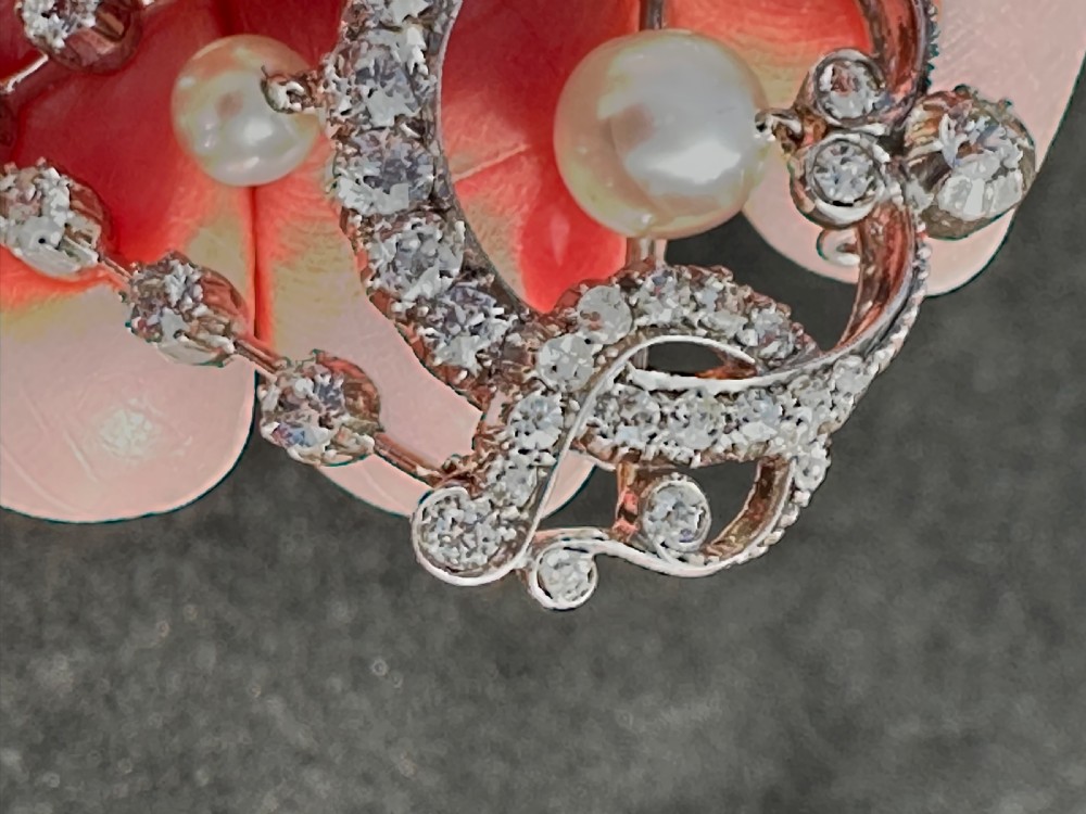 A platinum openwork pendant brooch featuring diamond-set scrollwork and three suspended natural pearl drops. View IX