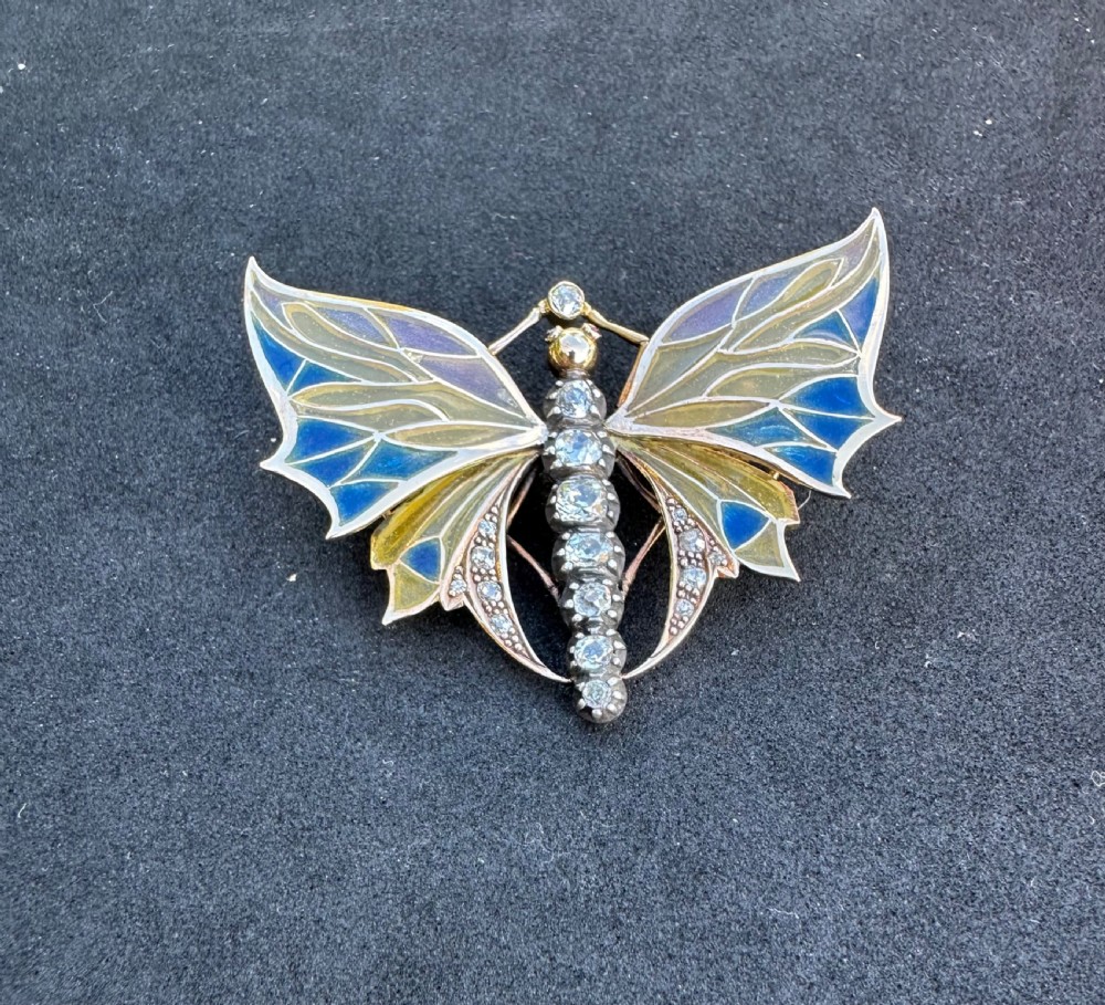 An Art Nouveau style butterfly brooch featuring blue and yellow plique-a-jour enamel wings with a diamond-paved body and gold framework. View III