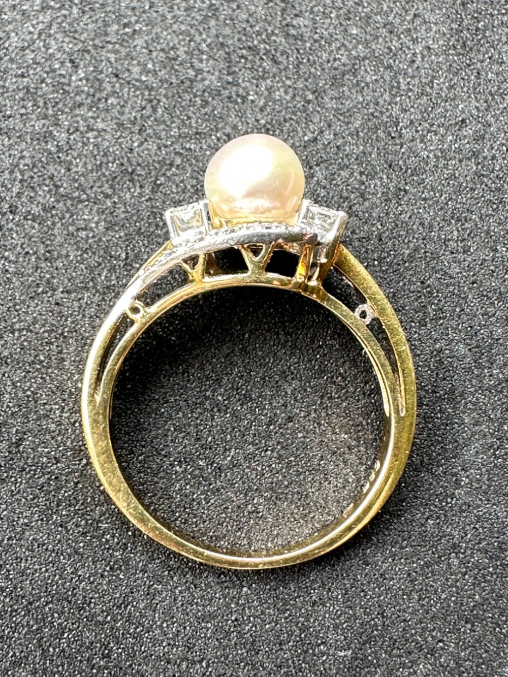 A 14ct gold crossover ring featuring a single central white pearl flanked by sweeping diamond-set bypass shoulders. View III