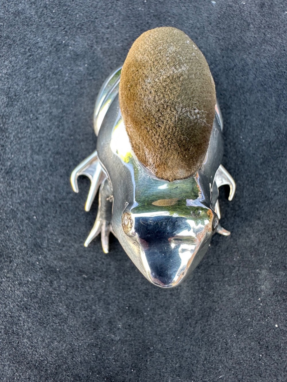 An Edwardian sterling silver pin cushion cast in the shape of a frog with an embedded brown fabric cushion on its back. View II