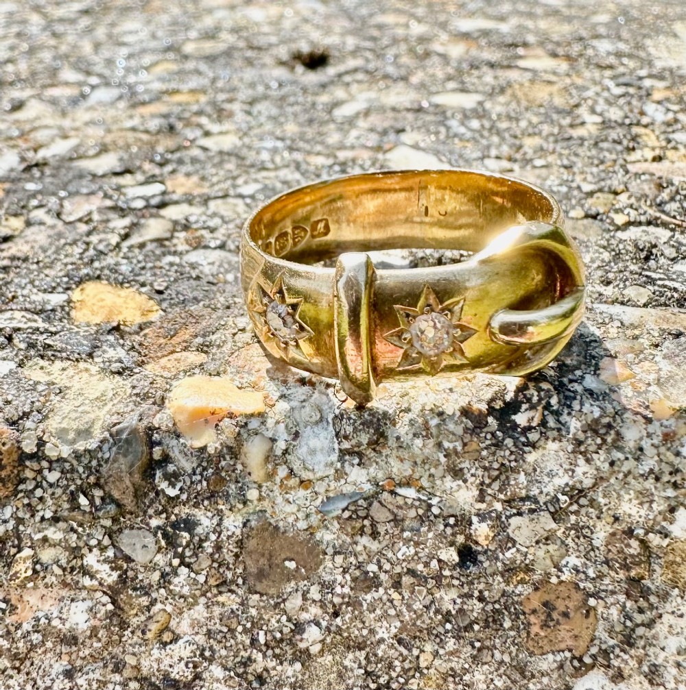 An 18 carat yellow gold band styled as a buckle motif with two star-set diamonds embedded on the surface. View VIII