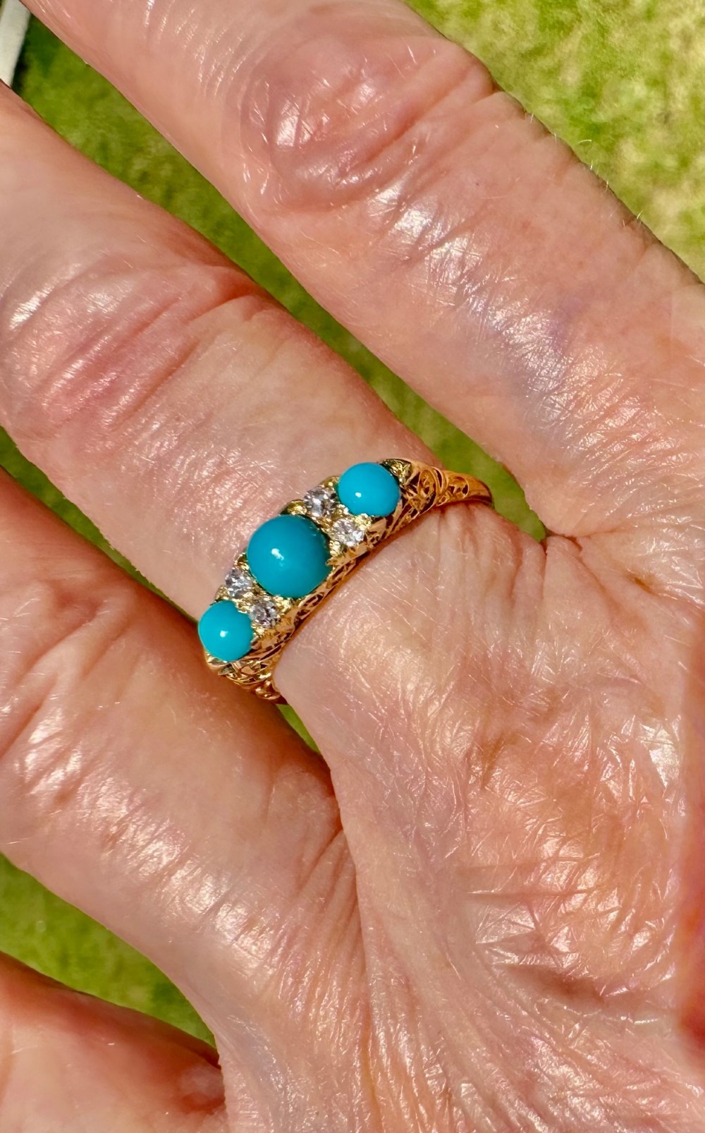 An antique 18ct yellow gold ring set with three turquoise cabochons and four small diamonds. View III