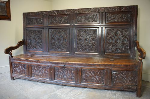 An Exceptional 17th Century Oak  Box Settle.