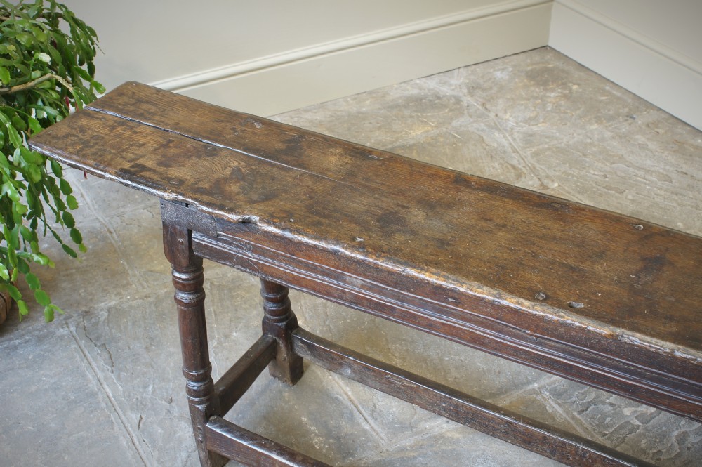 A 17th CENTURY JOINED OAK FORM OR BENCH, CIRCA 1640. View XVII