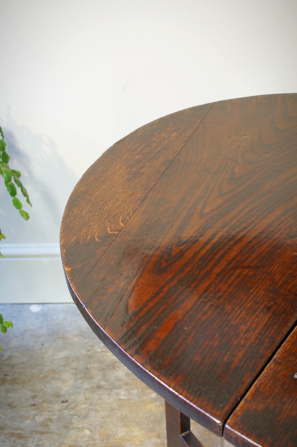 A small 17th-century dark oak gateleg table featuring bobbin-turned legs, drop-leaf top, and lower stretchers. View II