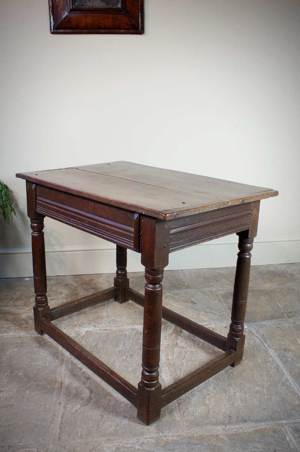 A seventeenth-century dark oak side table featuring a rectangular plank top, moulded apron, turned legs, and perimeter stretchers. View VII