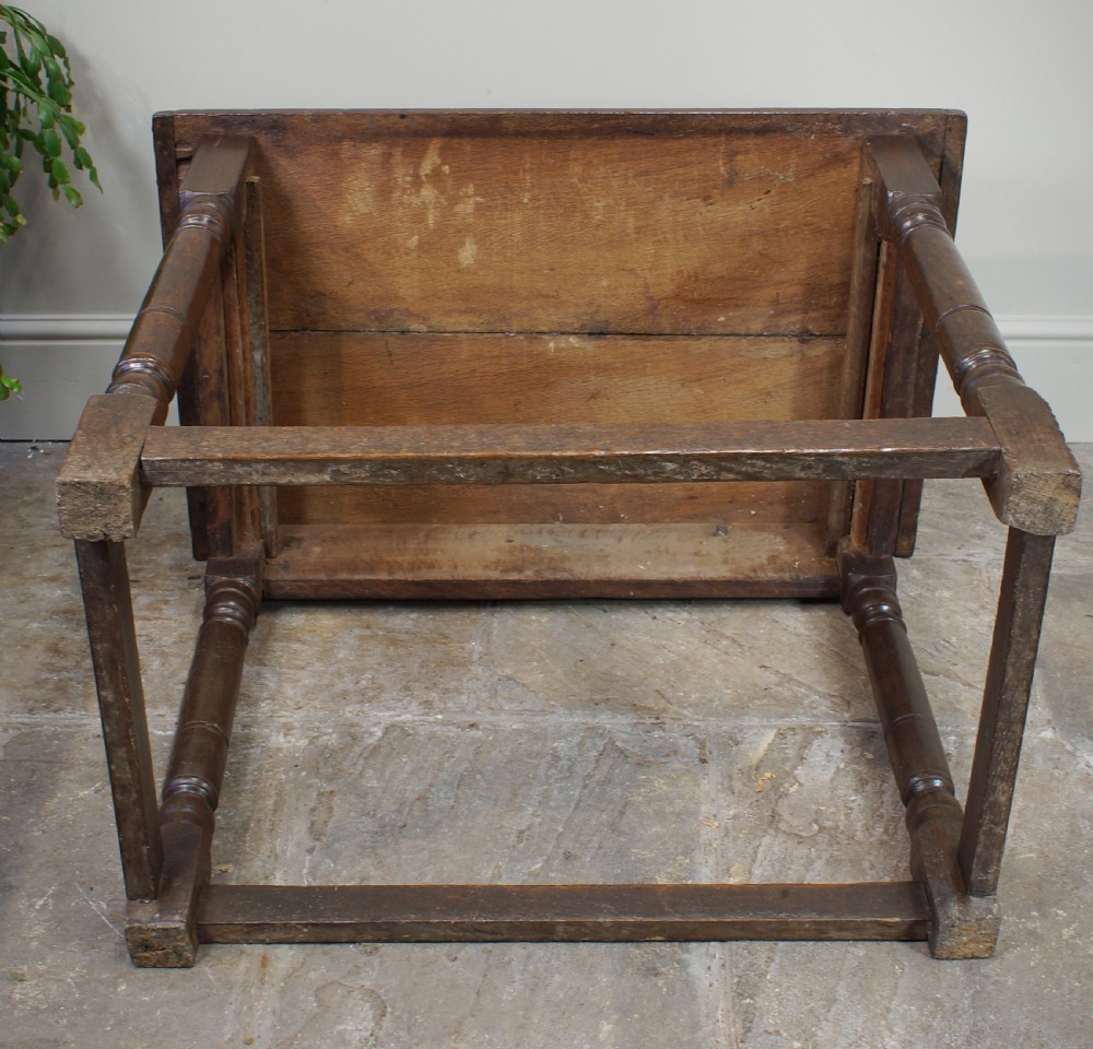 A seventeenth-century dark oak side table featuring a rectangular plank top, moulded apron, turned legs, and perimeter stretchers. View XIII