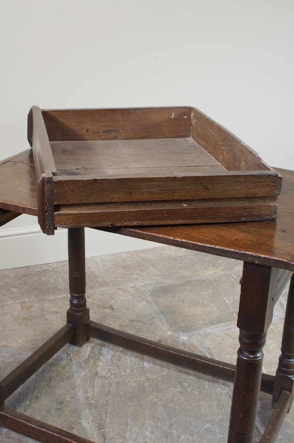 A seventeenth-century dark oak side table featuring a rectangular plank top, moulded apron, turned legs, and perimeter stretchers. View XIV