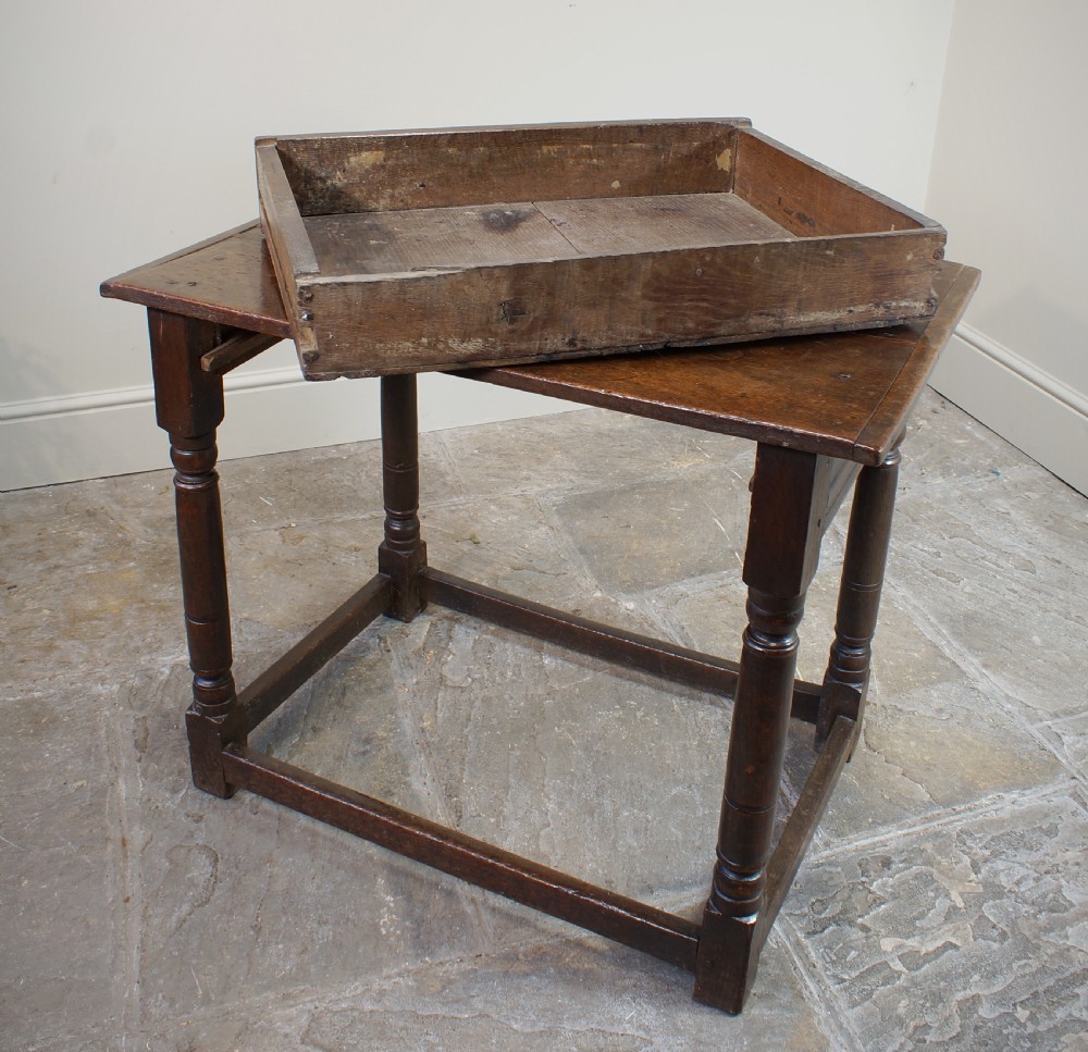 A seventeenth-century dark oak side table featuring a rectangular plank top, moulded apron, turned legs, and perimeter stretchers. View XV