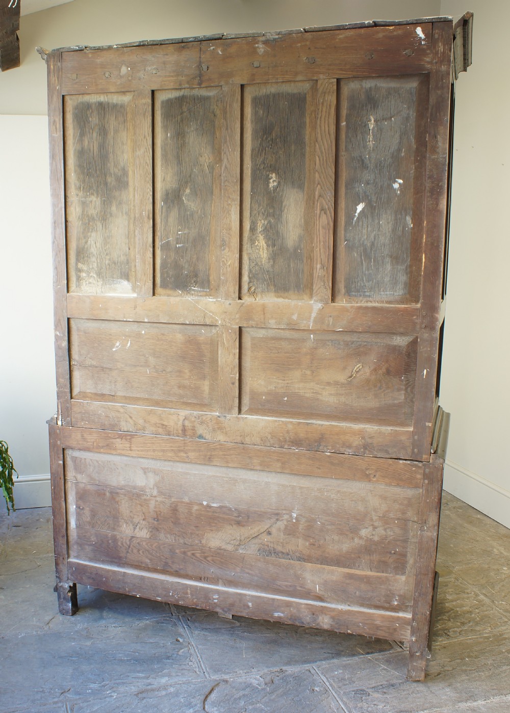 An 18th-century Georgian Welsh oak linen press cupboard featuring two arched panel doors over a base section with four rows of brass-handled drawers. View VII