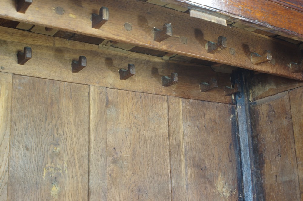 An 18th-century Georgian Welsh oak linen press cupboard featuring two arched panel doors over a base section with four rows of brass-handled drawers. View XI
