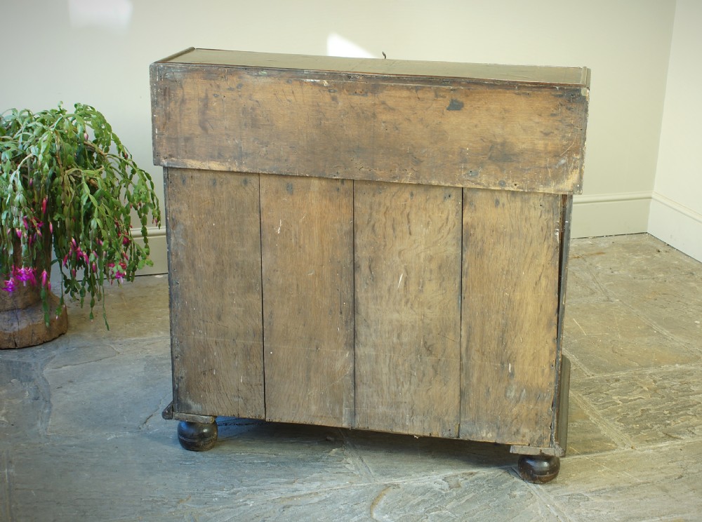 A William and Mary dark oak slant-front bureau featuring geometric parquetry on the lid, three long drawers with brass drop handles, and bun feet. View II