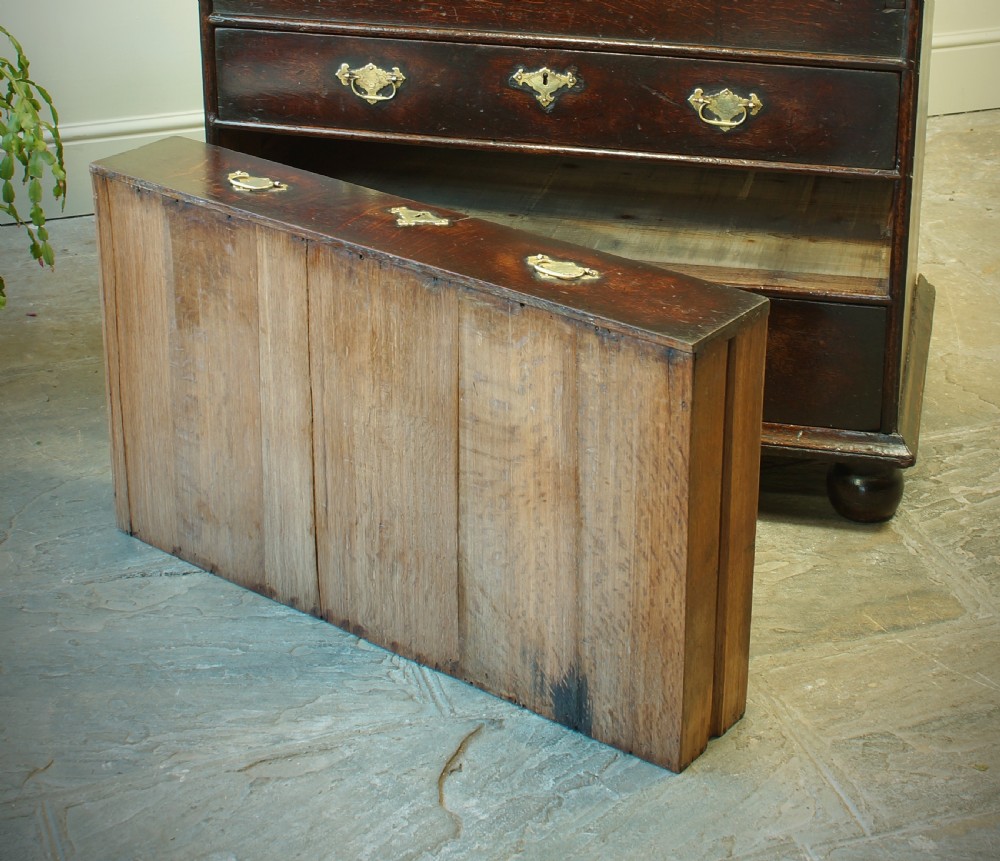 A William and Mary dark oak slant-front bureau featuring geometric parquetry on the lid, three long drawers with brass drop handles, and bun feet. View XIII