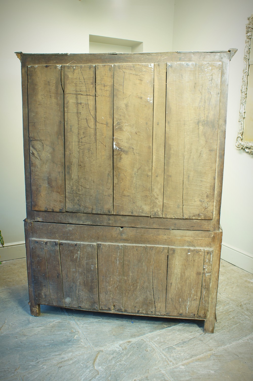 A Georgian oak linen press featuring two arched upper panel doors over a lower chest section with decorative brass hardware. View XI