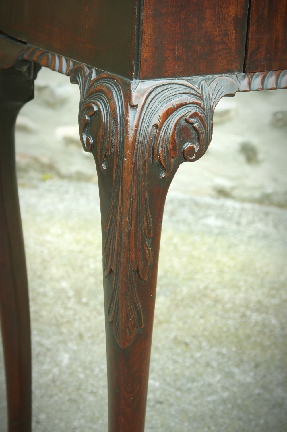 A George II mahogany fold-over card table featuring carved cabriole legs with ball-and-claw feet and a central drawer. View VI