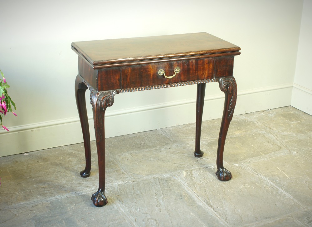 A George II mahogany fold-over card table featuring carved cabriole legs with ball-and-claw feet and a central drawer. View XI