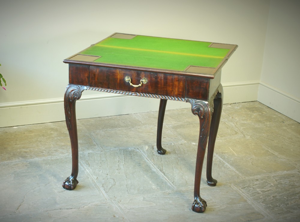 A George II mahogany fold-over card table featuring carved cabriole legs with ball-and-claw feet and a central drawer. View XII