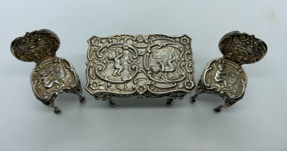 Miniature silver table and chairs.