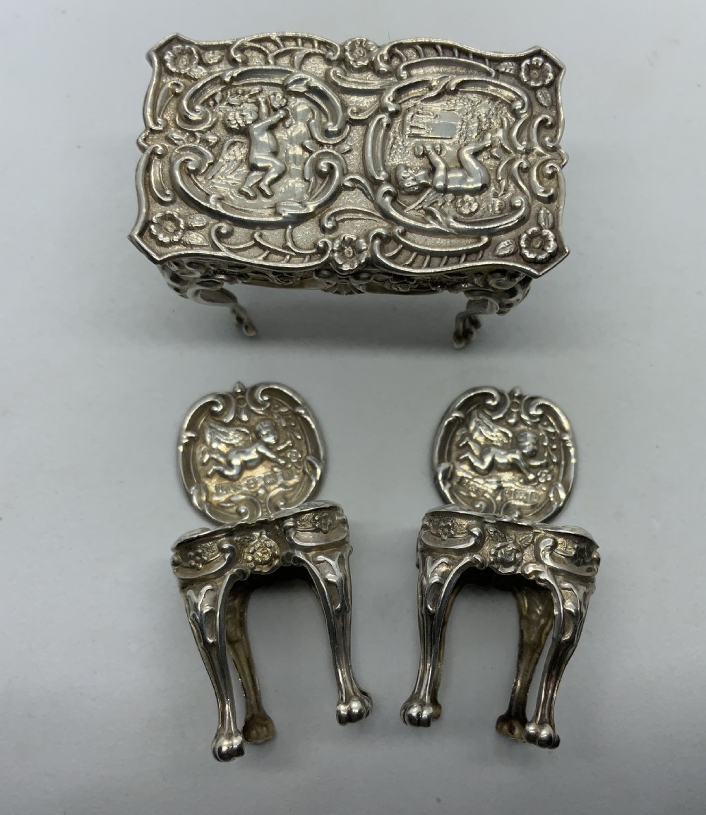 Miniature silver table and chairs. View II