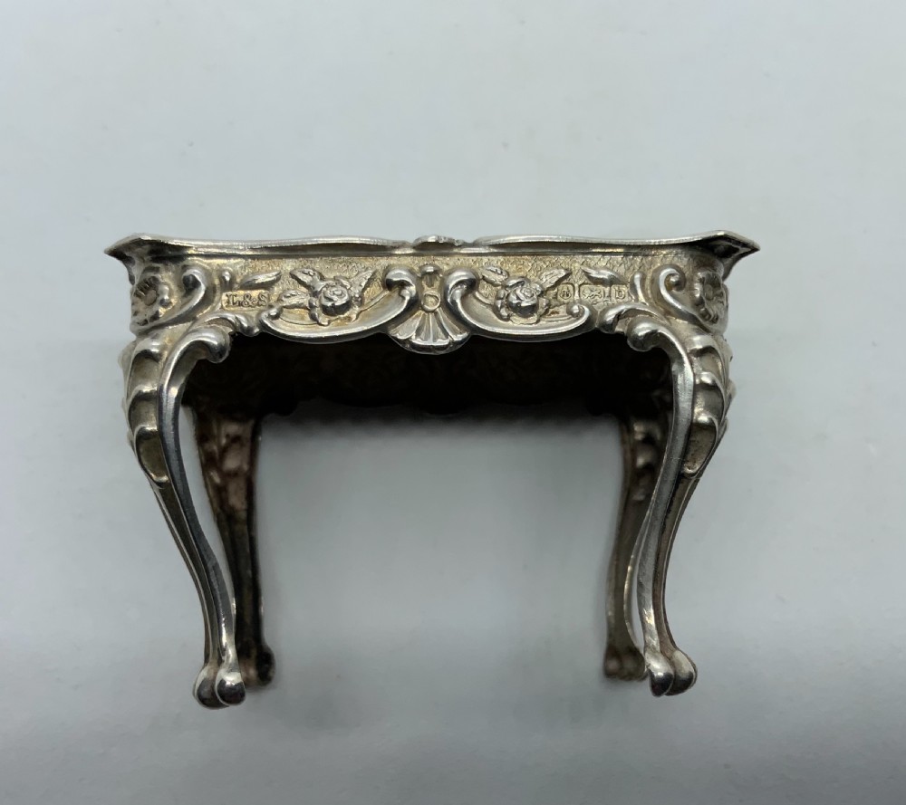 Miniature silver table and chairs. View III