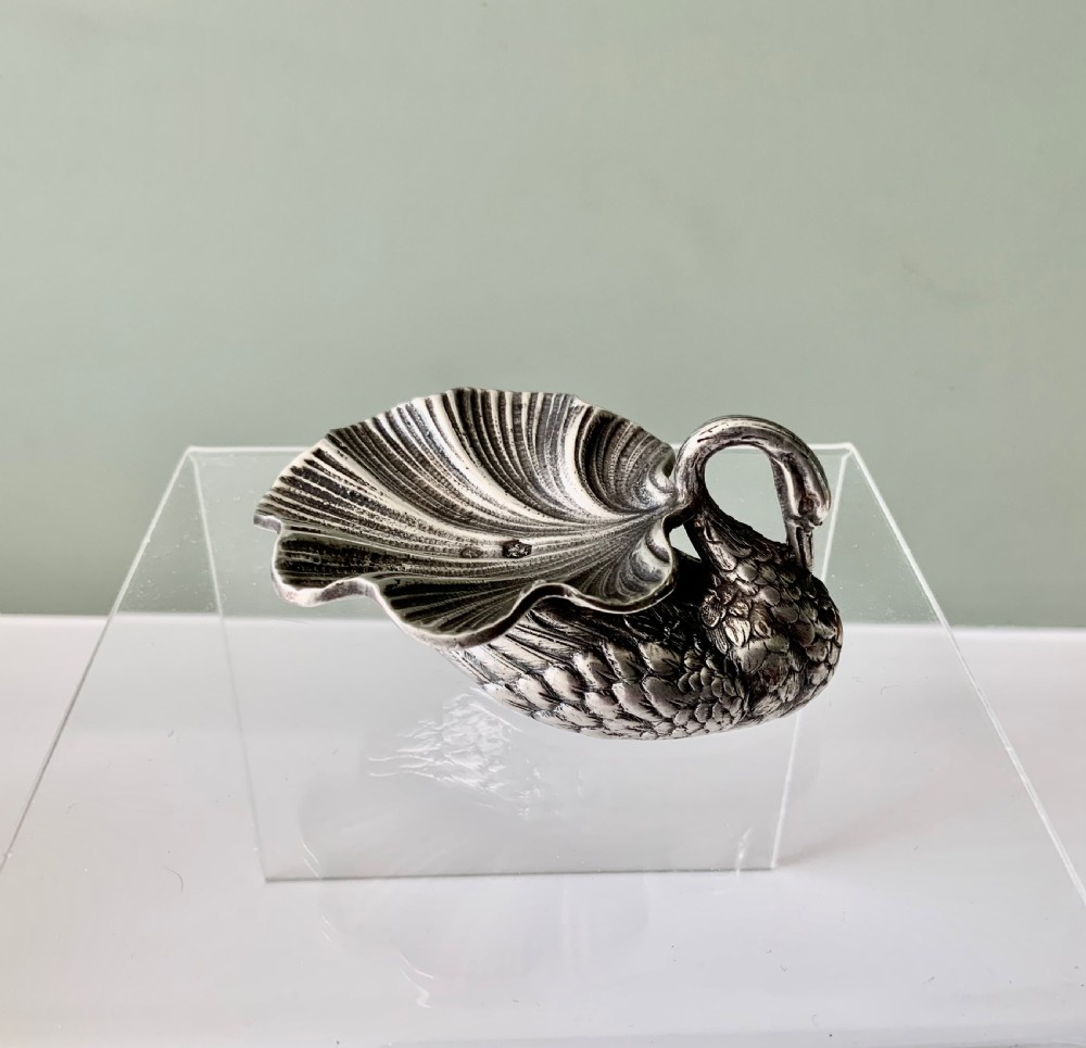 A silver salt cellar fashioned in the shape of a swan with detailed feather texture and a ribbed shell-shaped dish on its back. View III