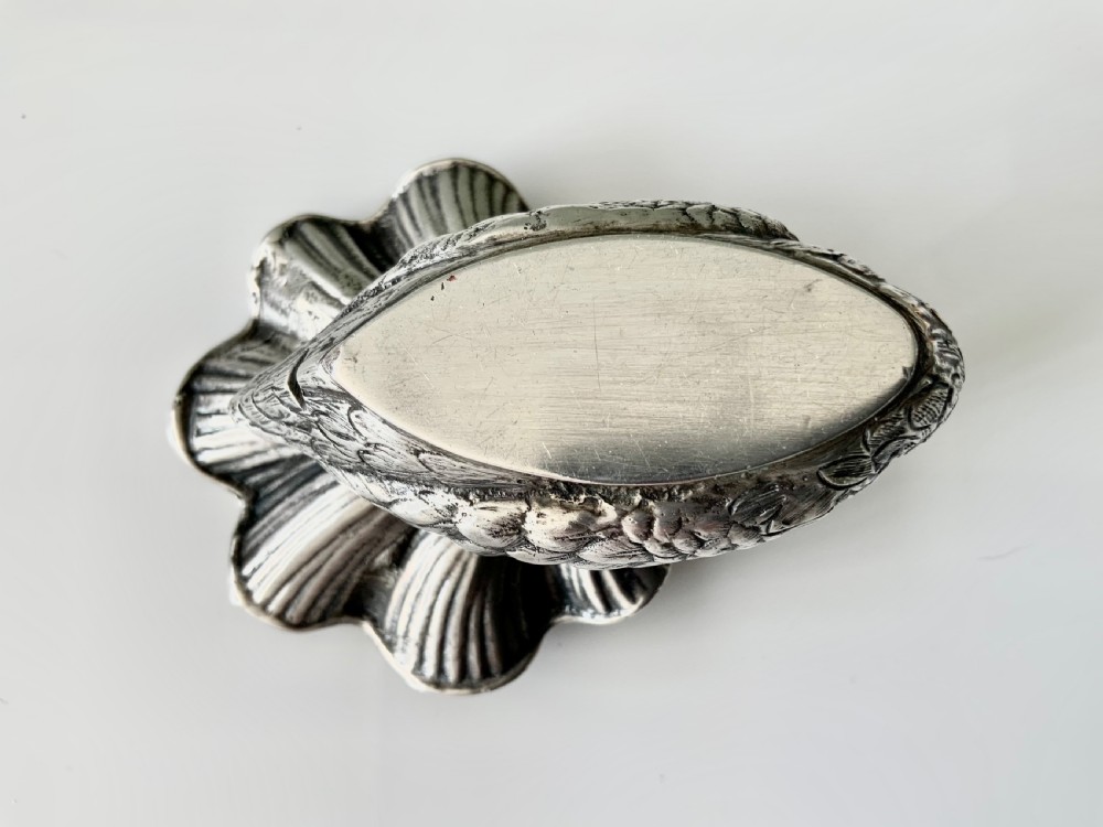 A silver salt cellar fashioned in the shape of a swan with detailed feather texture and a ribbed shell-shaped dish on its back. View VI
