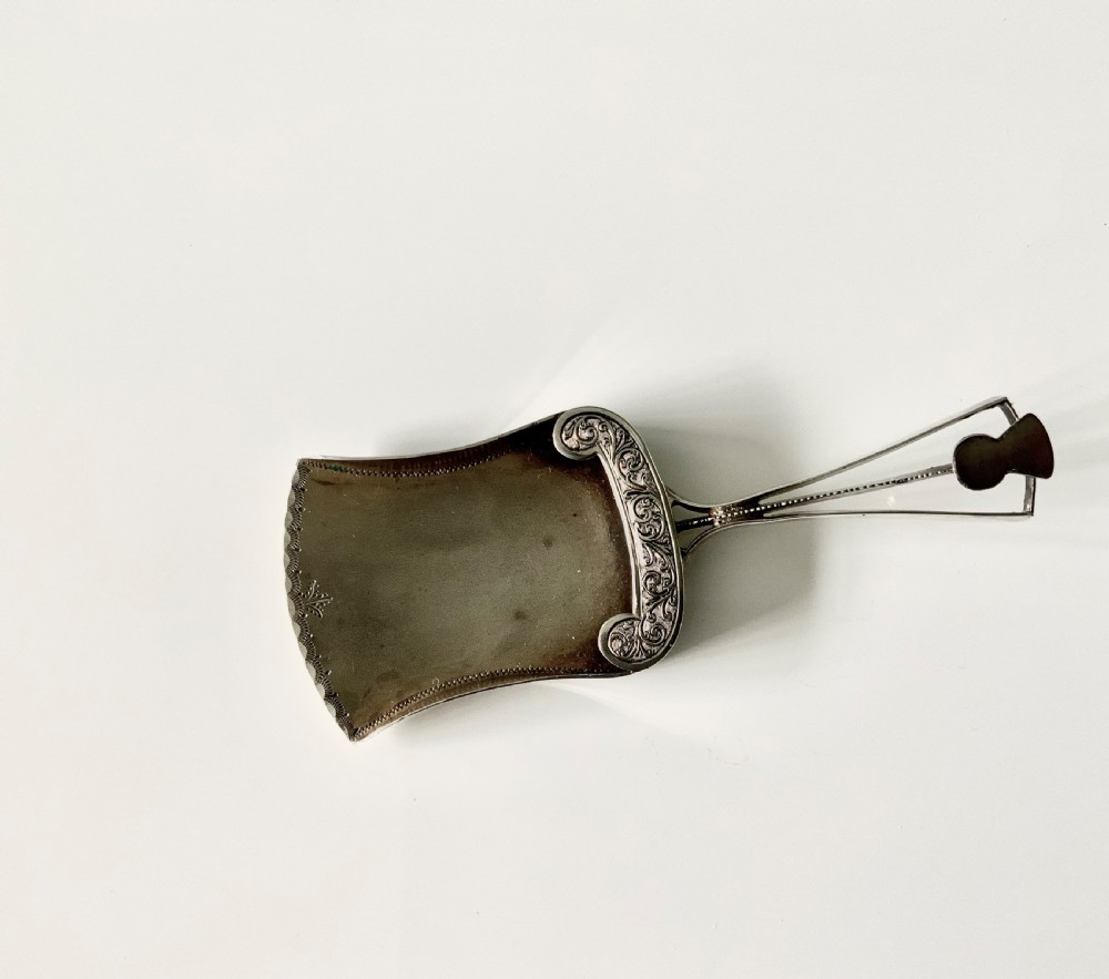 Silver caddy spoon, unusual shape, thistle decoration
 View IV