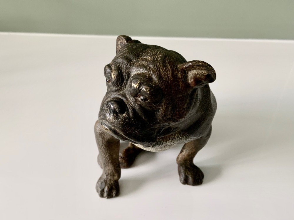 A dark cold-painted bronze sculpture of a bulldog seated on its hind legs. View II
