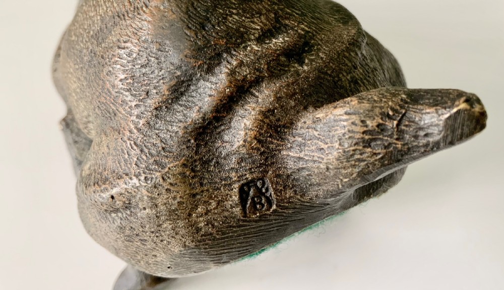 A dark cold-painted bronze sculpture of a bulldog seated on its hind legs. View VI