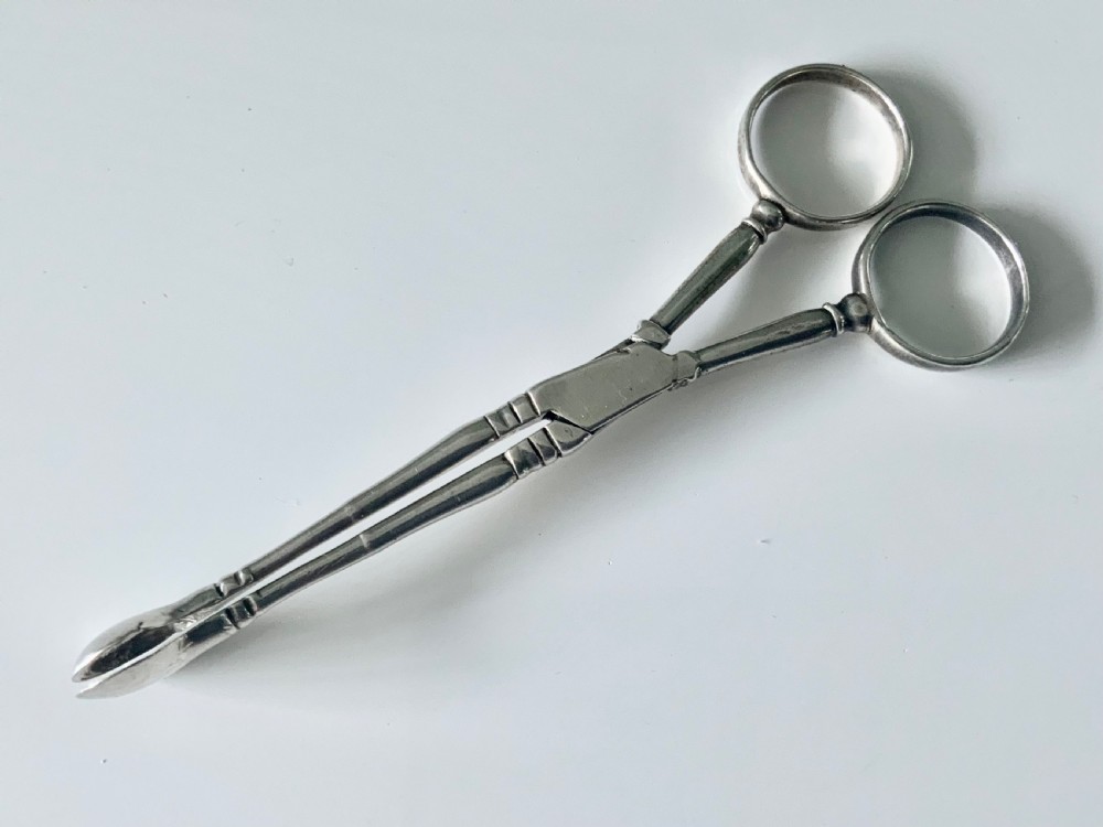 Early Baluster pair of silver tea tongs View II