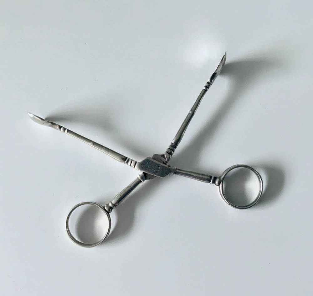 Early Baluster pair of silver tea tongs View III
