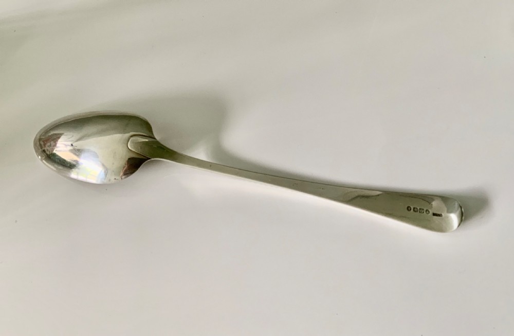 A Victorian sterling silver gravy spoon featuring an elongated oval bowl and a tapered handle decorated with geometric borders. View III