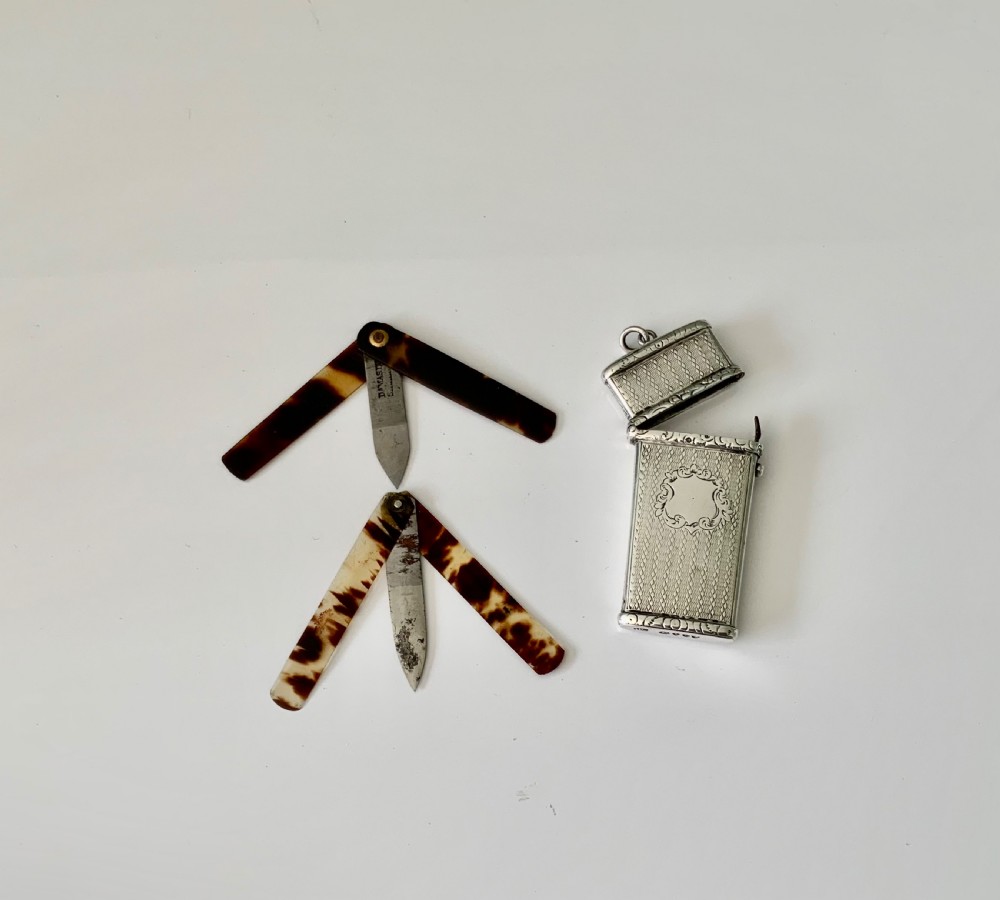 An open Victorian engine-turned sterling silver medical etui featuring a blank central cartouche, suspension loop, and fitted interior containing folding lancets. View III