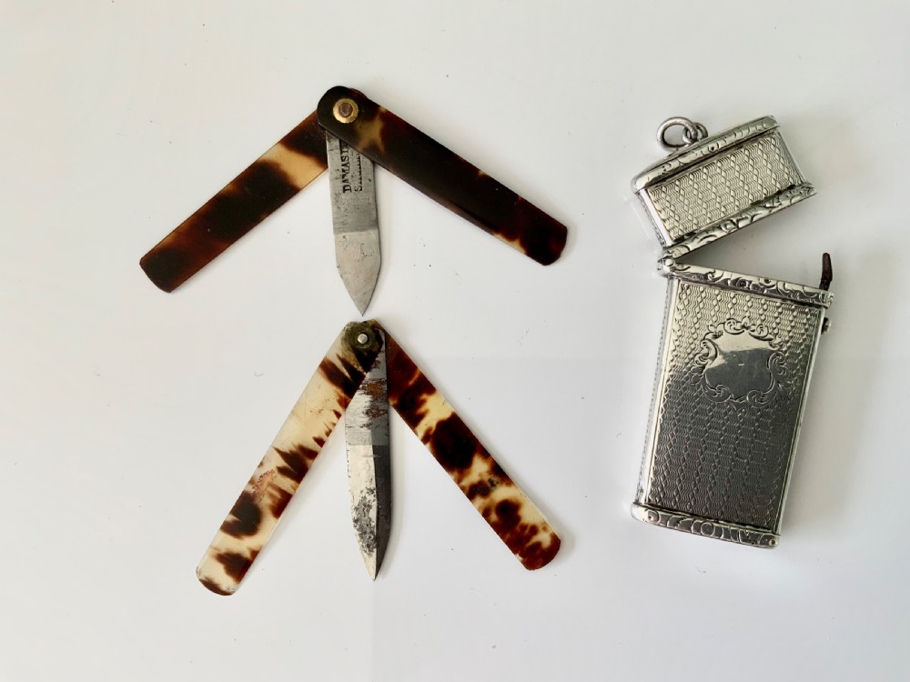 An open Victorian engine-turned sterling silver medical etui featuring a blank central cartouche, suspension loop, and fitted interior containing folding lancets. View IV