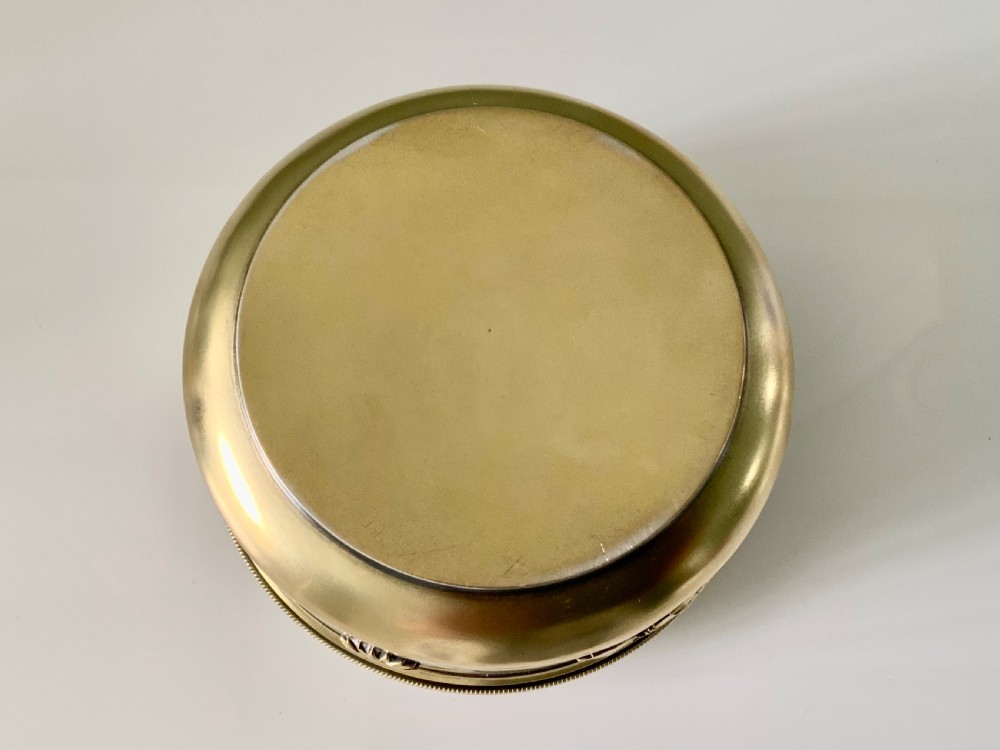 Top view of a round French vermeil silver covered bowl featuring relief carvings of floral rosettes and laurel foliage swags. View II